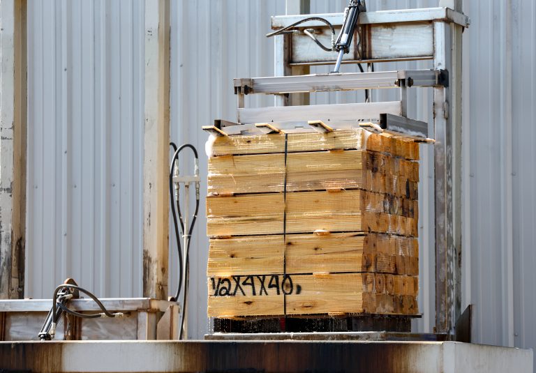 Pallets getting dipped in PQ-8 for an FDA-approved mold resistance